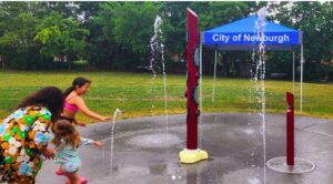 kids playing at the sprinklers at playground