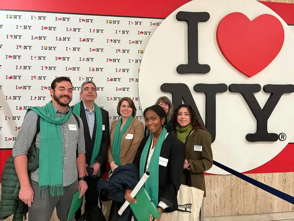 group of people in front of I LOVE NY sign