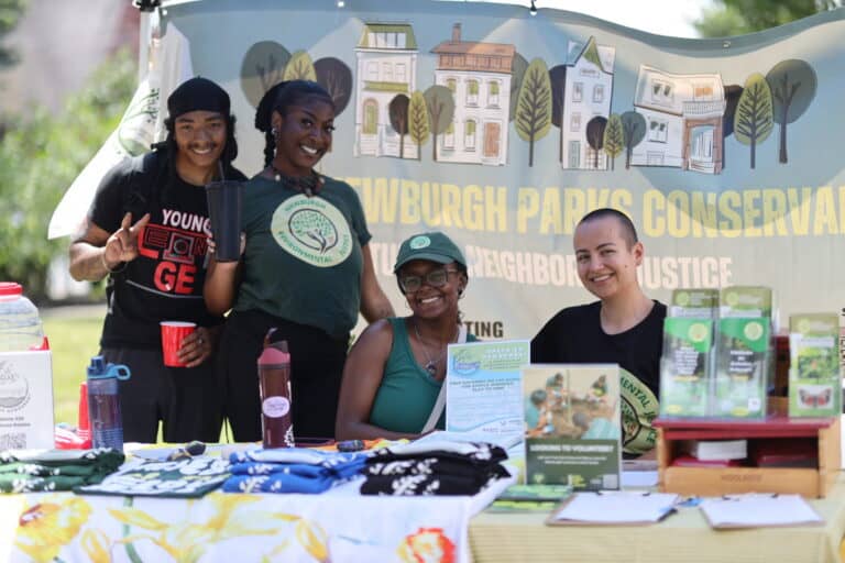 Outdoor Promise youth and partners at a community table