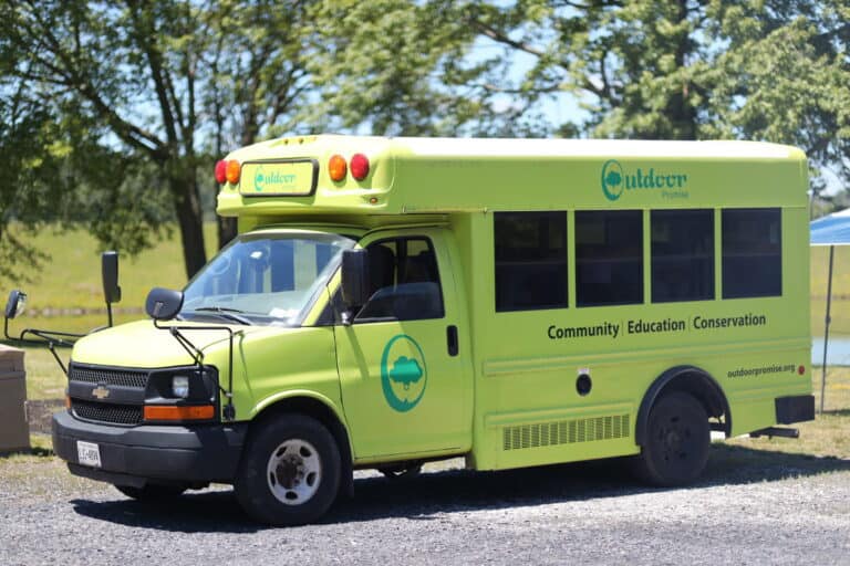 The lime-green Outdoor Promise Adventure Bus