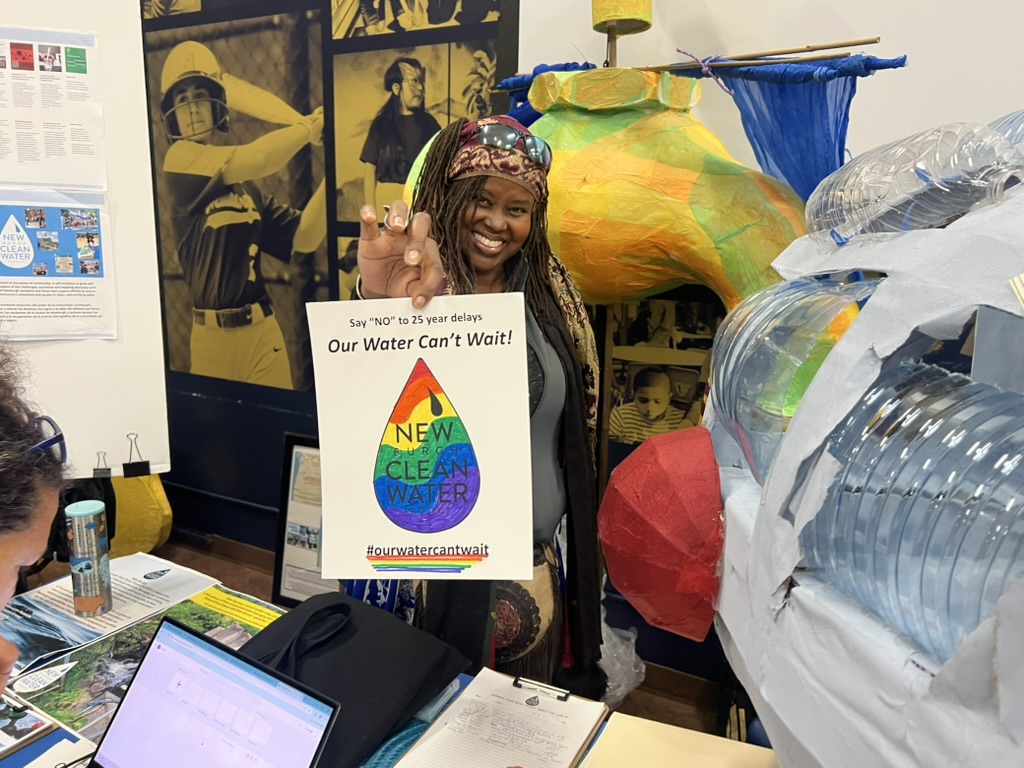 The plastic-bottle installation made after Clean Water Community Day, shown at the October 21 Restoration Advisory Board poster session at the Newburgh Free Library, with a Newburgh Clean Water Project volunteer