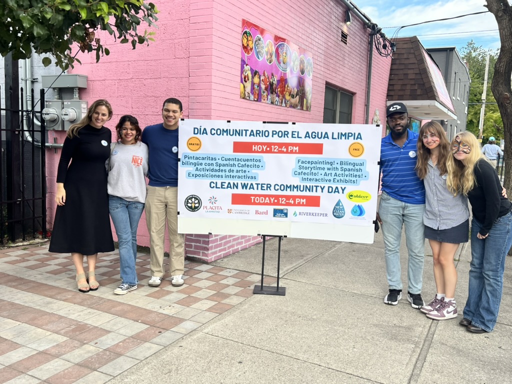 The organizing team at the bilingual Clean Water Community Day sign outside Placita La Amistad in Newburgh